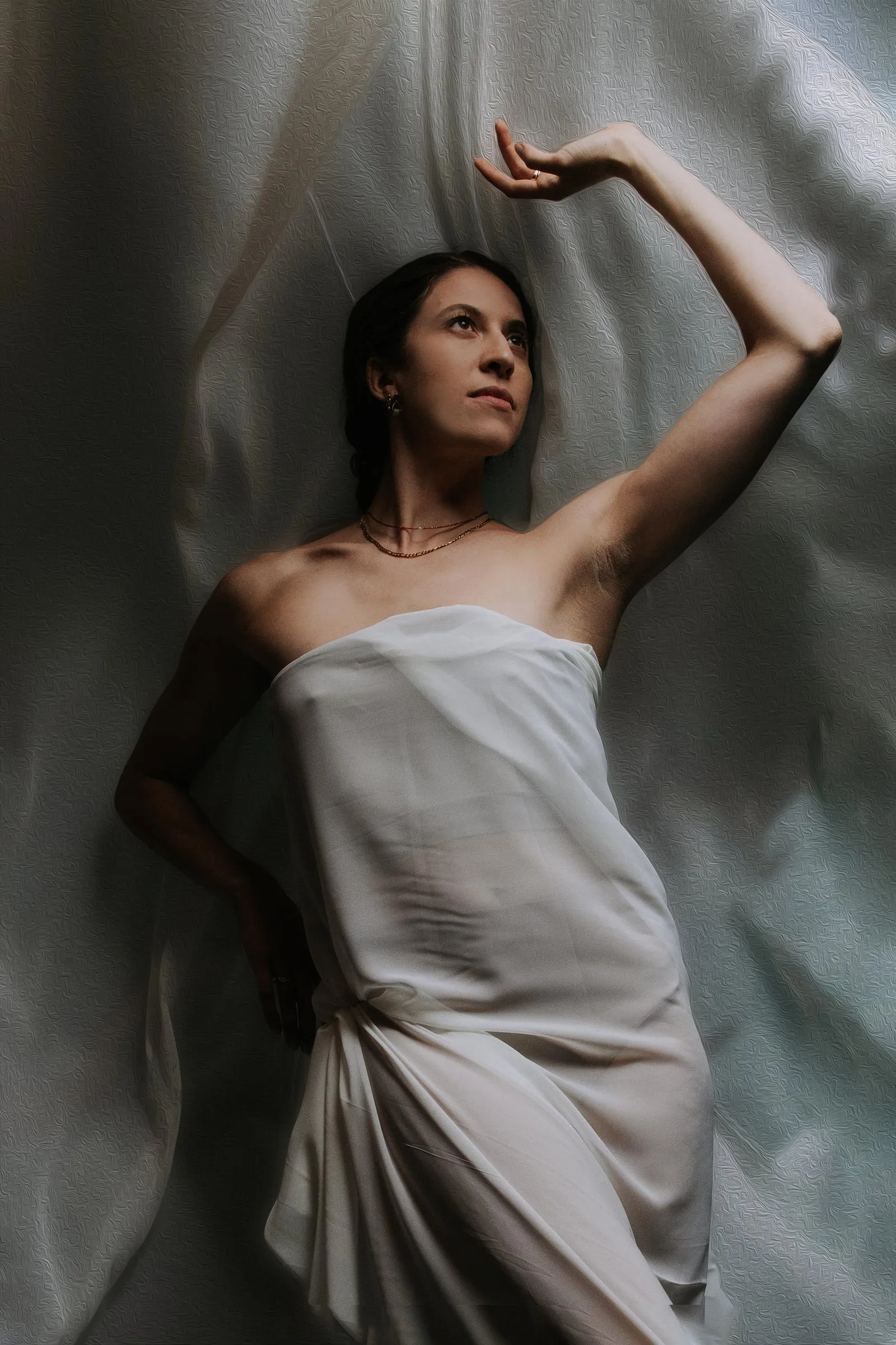 Alex Schooling posed against a wall of white silk