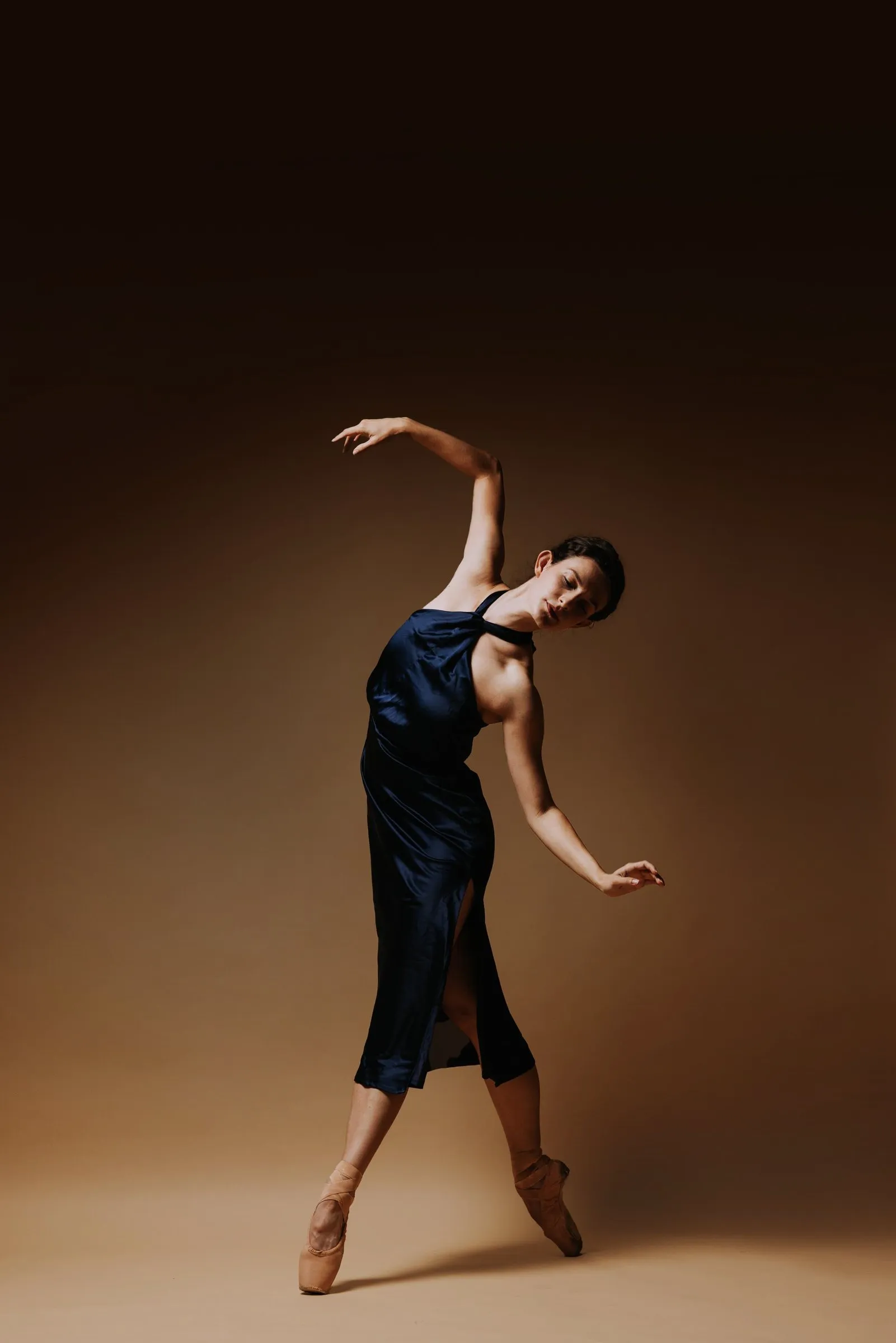 Grace Manuel leaning back with one arm curved overhead